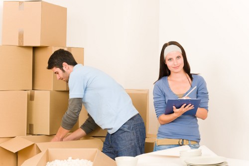 Specialist movers handling a grand piano move in Roehampton